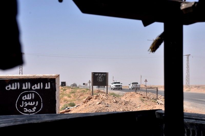 Billboards show the logo of the Daesh terrorist group near the village of al-Malihah, in the countryside of Deir el-Zor, where Assad regime forces are holding a position on Sept. 9, 2017, during the ongoing battle against the terrorists. (AFP Photo)