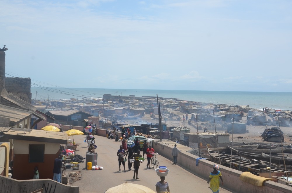 Locals walk along a coastal street in Ghana's capital city of Accra, Oct. 11.