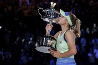 Sofia Kenin of the U.S. kisses the Daphne Akhurst Memorial Cup aloft after defeating Spain's Garbine Muguruza in the women's singles final at the Australian Open tennis championship in Melbourne, Australia, Saturday, Feb. 1, 2020. (AP Photo)