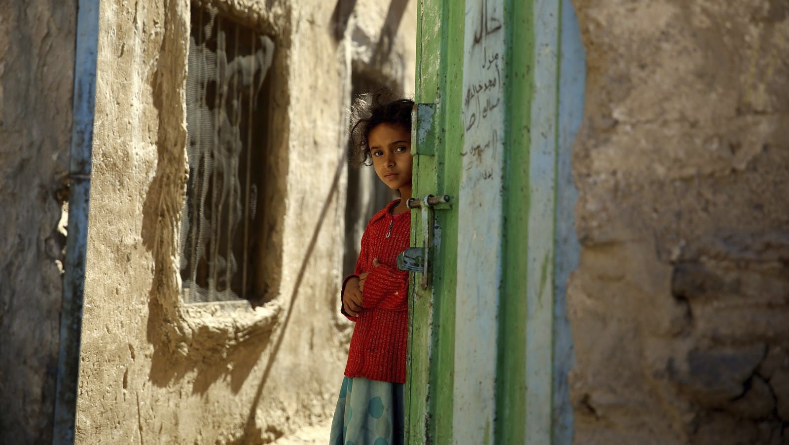 A Yemeni girl stands in a doorway in the conflict zone in Sanaa, Yemen, Nov. 9, 2015.