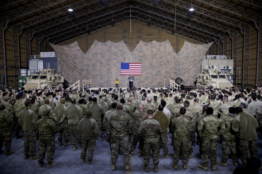 In a surprise visit to the U.S.' al-Asad Air Base in Iraq, U.S. President Donald Trump defended his decision to withdraw U.S. troops from Syria, Dec. 26.