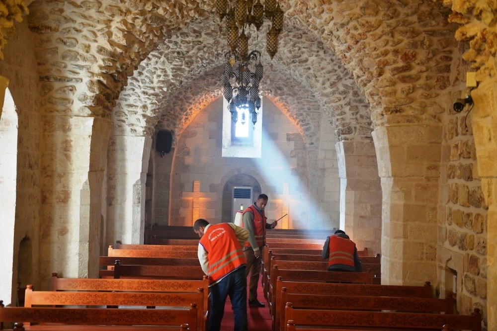 Municipality workers clean a church in the town of Artuklu.