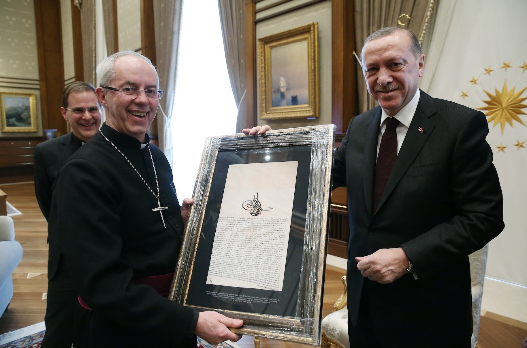 President Erdou011fan presented Archbishop Welby (L) with a copy of a letter from Sultan Murad III to Queen Elizabeth I.