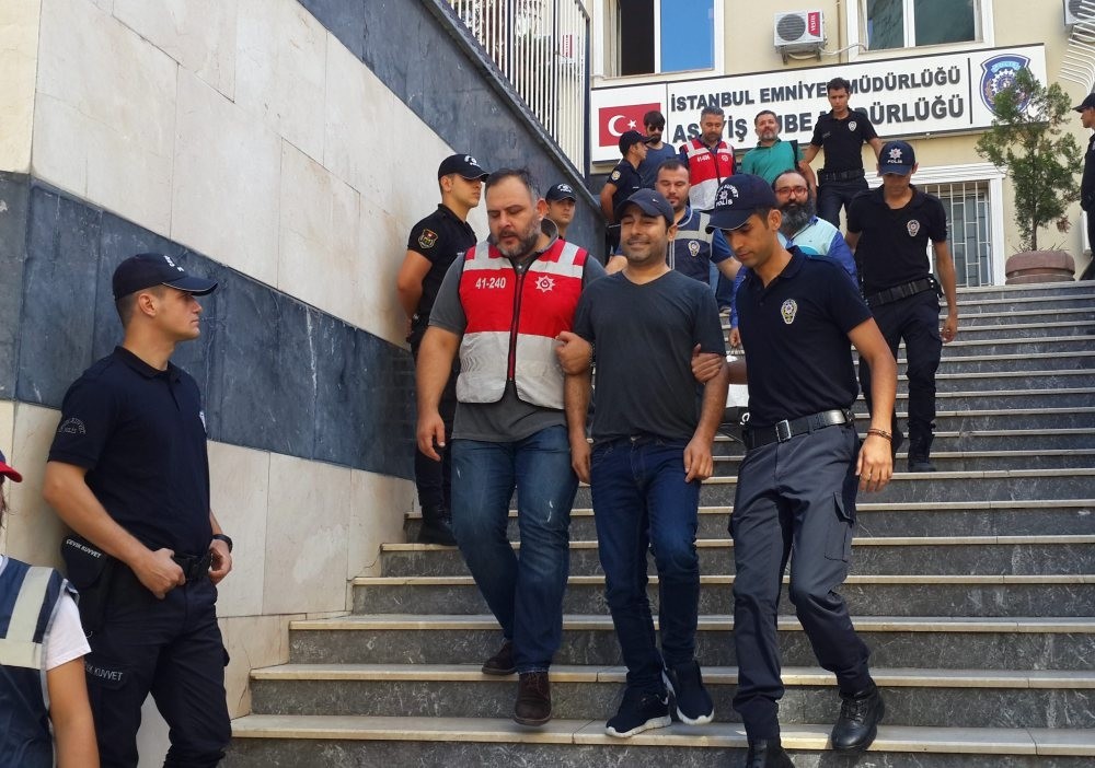 Atilla Tau015f, one of the defendants, is seen being escorted by police as he leaves a police station following his detention last year.