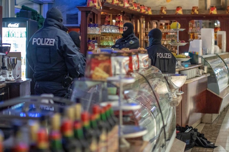Policemen raid an ice cafe in Duisburg, western Germany, on December 5, 2018. (AFP Photo)