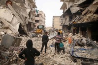 Members of the Syrian Civil Defence, also known as the White Helmets, watch as a bulldozer clears rubble and debris at the site of reported airstrikes on the town of Ariha, Idlib, Jan. 30, 2020. (AFP Photo)