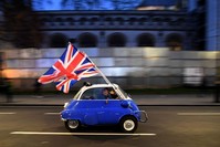 A man waves Union flags from a small car as he drives past Brexit supporters gathering in Parliament Square, central London, Jan. 31, 2020, the day that the U.K. formally left the EU. (AFP Photo)