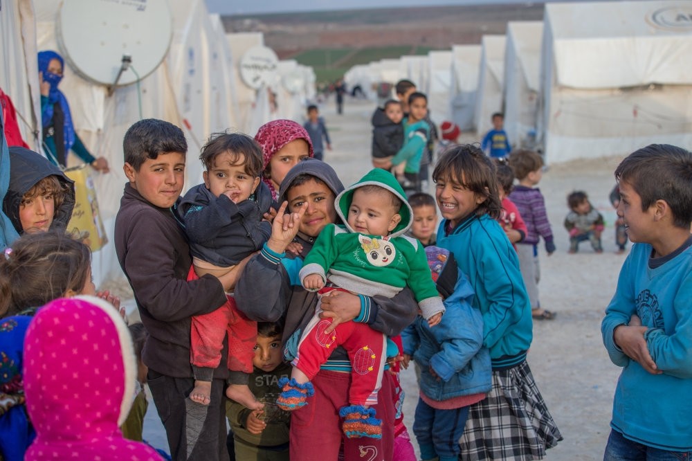 Children of Syrian Kurdish families who escaped from YPG-dominated areas and took refuge in Turkey pose at a camp in the southern province of u015eanlu0131urfa, Dec. 3.