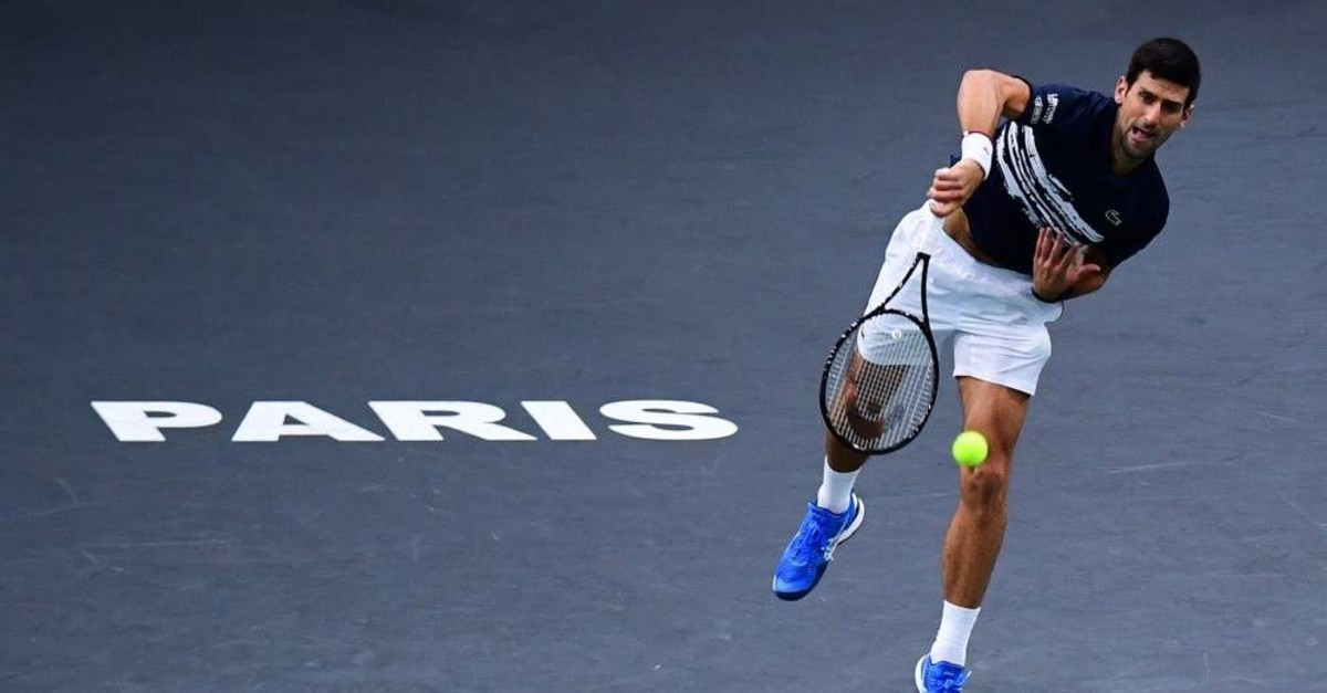Serbia's Novak Djokovic returns the ball to Canada's Denis Shapovalov during their men's singles final tennis match at the ATP World Tour Masters 1000 - Rolex Paris Masters - indoor tennis tournament at The AccorHotels Arena in Paris on November 3, 2019. (Photo by MARTIN BUREAU / AFP)