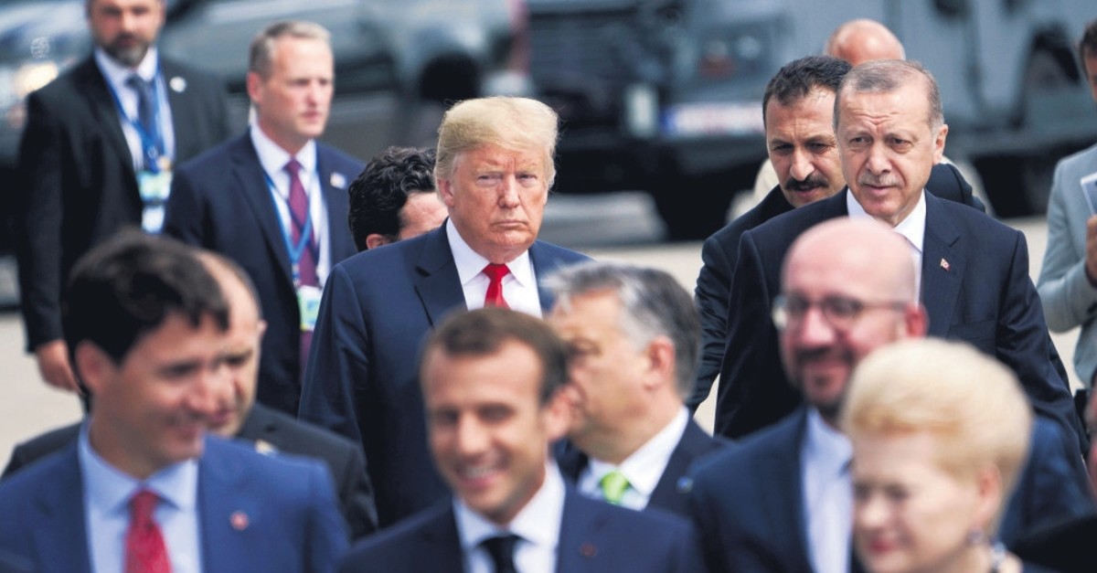 President Recep Tayyip Erdou011fan (R) and U.S. President Donald Trump (L) talk during the walk to take the family photo at the NATO summit in Brussels, July 11, 2018.