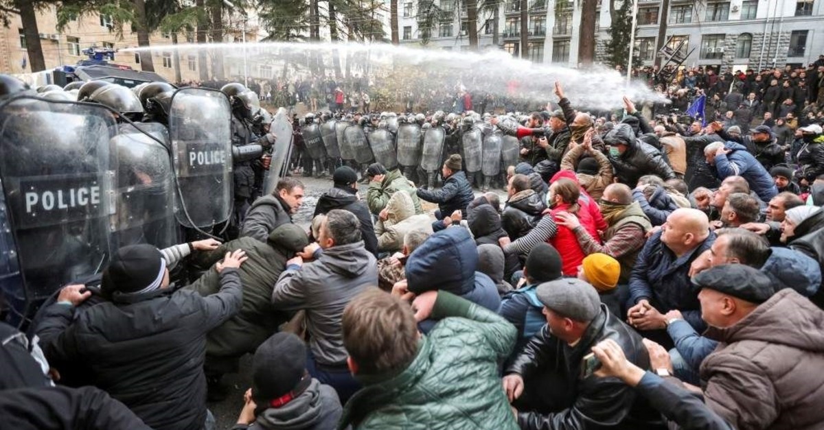 Riot police use a water cannon to disperse demonstrators during a protest against the government demanding an early parliamentary election, Tbilisi, Georgia, Nov.18, 2019. (Reuters Photo)