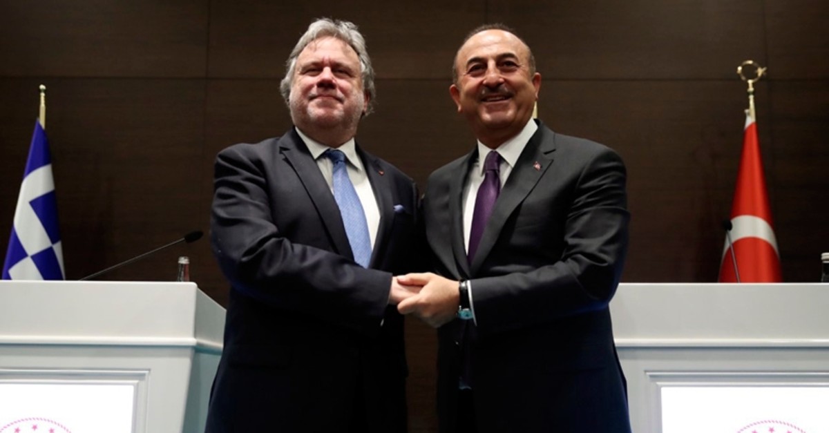 Foreign Minister Mevlu00fct u00c7avuu015fou011flu, right, and his Greek counterpart Giorgos Katrougalos pose for photos after a news conference in the Mediterranean coastal city of Antalya, Turkey, Thursday, March 21, 2019. (Foreign Ministry via AP, Pool)