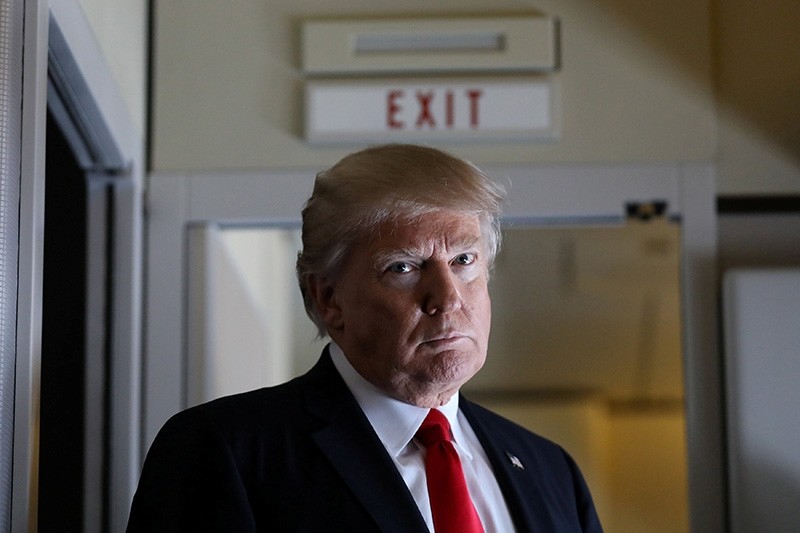 U.S. President Donald Trump pauses as he talks to journalists who are members of the White house travel pool on board Air Force One during his flight to Palm Beach, Florida while over South Carolina, U.S., Feb. 3, 2017. (Reuters Photo)