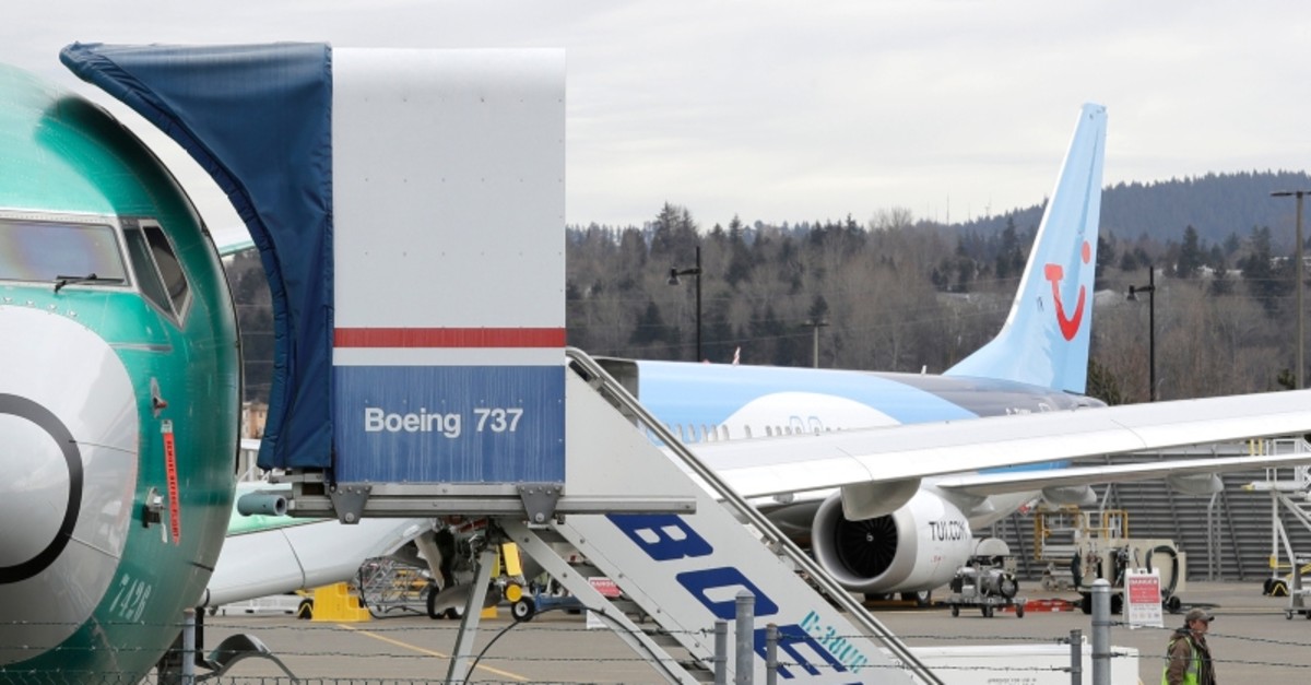 In this photo taken Monday, March 11, 2019, a Boeing 737 MAX 8 airplane being built for TUI Group sits parked in the background at right at Boeing Co.'s Renton Assembly Plant in Renton, Wash. (AP Photo)