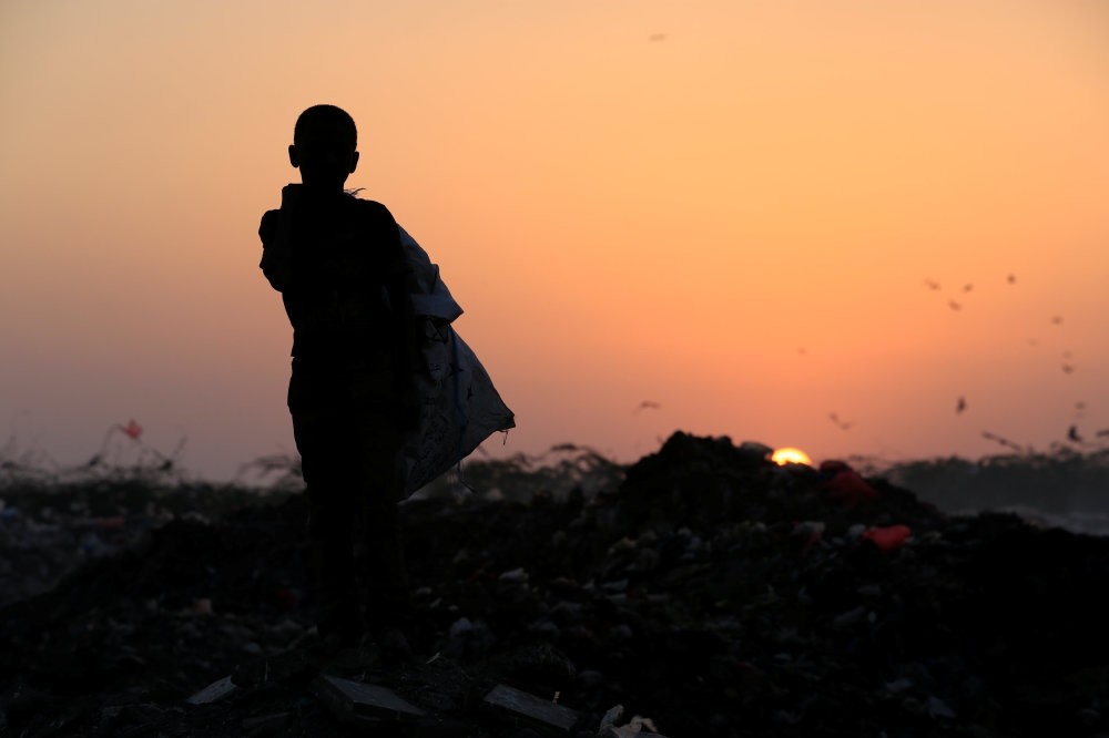 A Yemeni boy stands in a garbage dump where he collects recyclables and food near the Red Sea port city of Hodeidah, Yemen. (Reuters Photo)