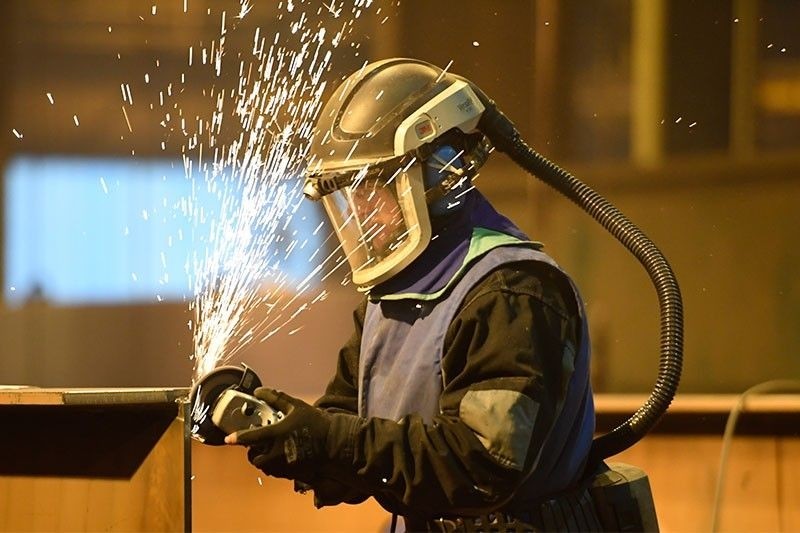 In this file photo taken on December 14, 2018 a man works in the naval workshop of Flensburg as the inauguration of ,Honfleur,, the new ferry of ,Brittany Ferry,, took place on December 14, 2018. (AFP Photo)