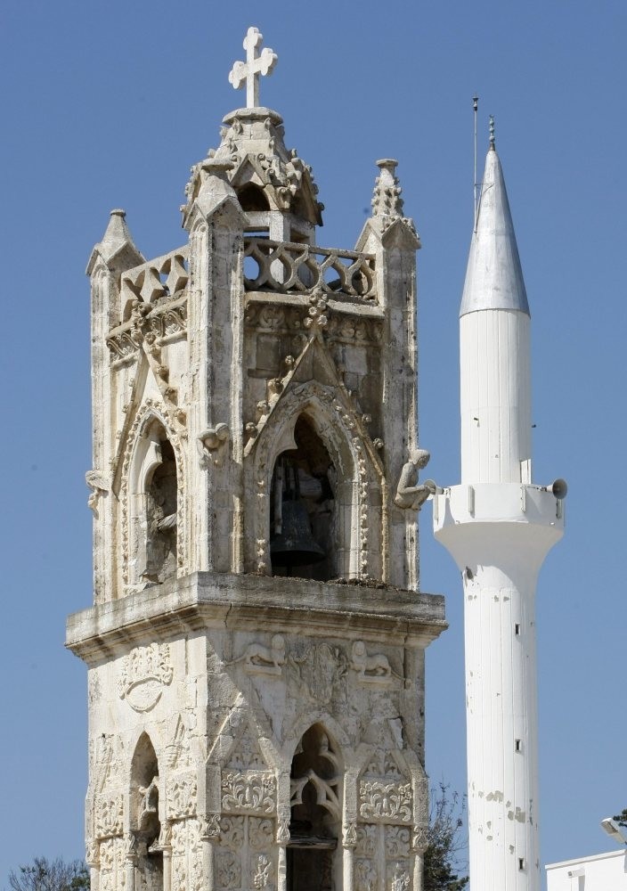 The campanile of an Orthodox church (L) and a minaret are seen in Dipkarpaz, Riso Karpaso, some 150 km (93 miles) east of Nicosia, in the Turkish administered northern part of Cyprus. 