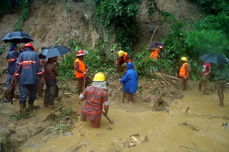 Bangladeshi fire fighters search for bodies after a landslide in Bandarban on June 13, 2017. (AFP Photo)