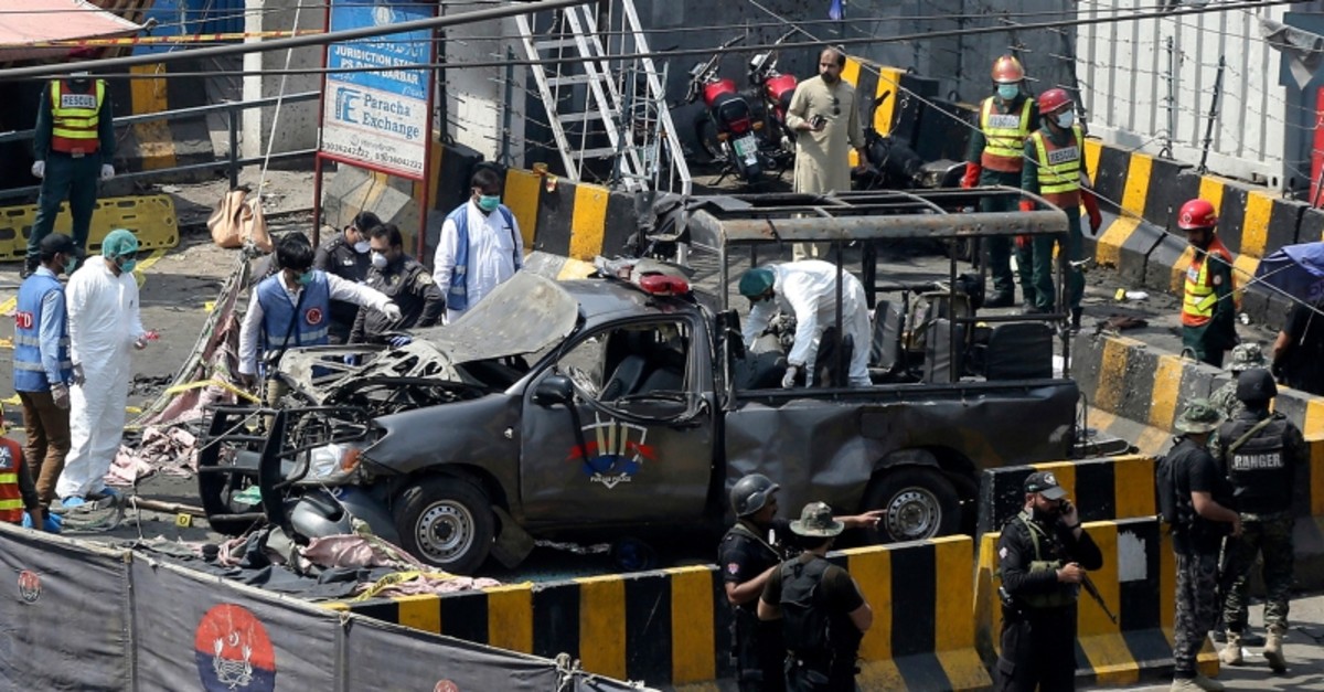 Pakistani security personnel surround a damaged police van in Lahore, Pakistan, Wednesday, May 8, 2019. (Reuters Photo)