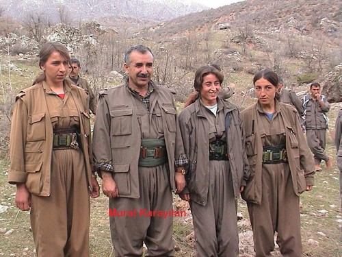 PKK leader Murat Karayılan stands next to female militants.