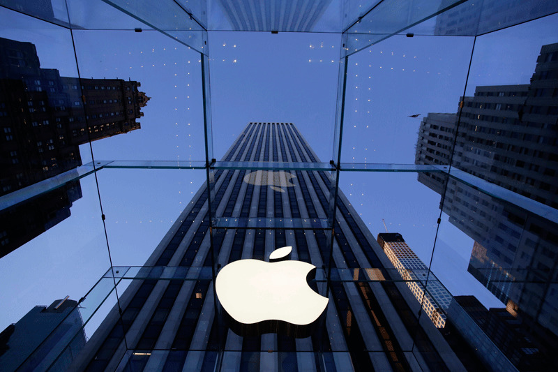 In this photo, the Apple logo hangs in the glass box entrance to the company's Fifth Avenue store, in New York (AP File Photo)