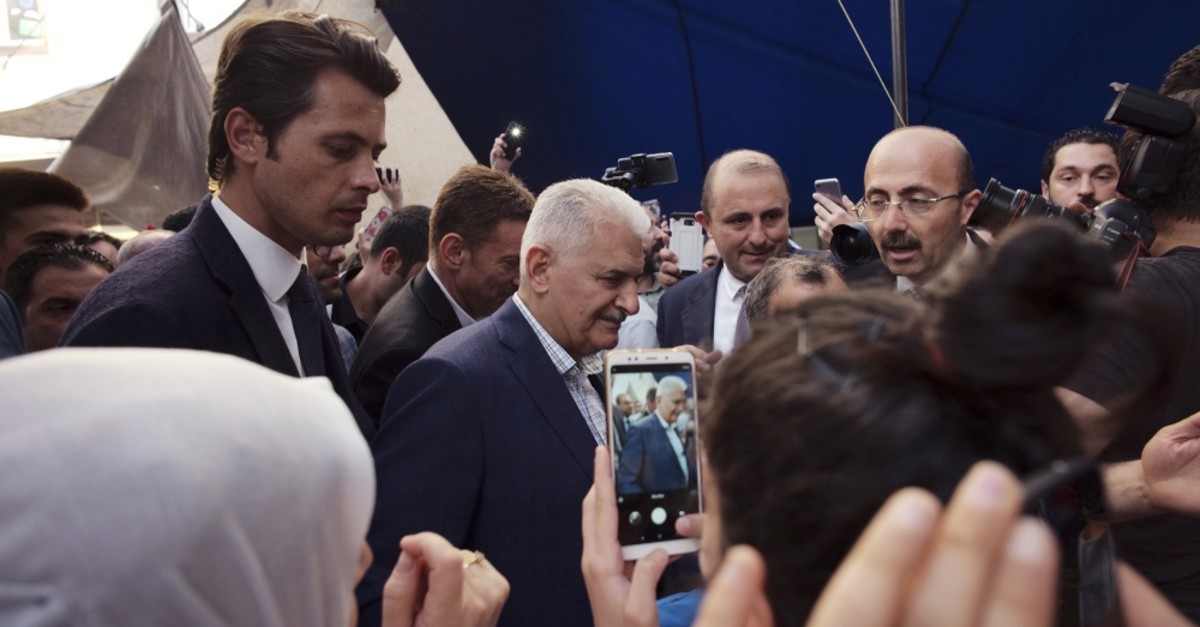 Binali Yu0131ldu0131ru0131m (C), the Istanbul mayoral candidate from the ruling AK Party, surrounded by supporters and party officials as he visits a market before the June 23 rerun elections, Istanbul, June 11, 2019.