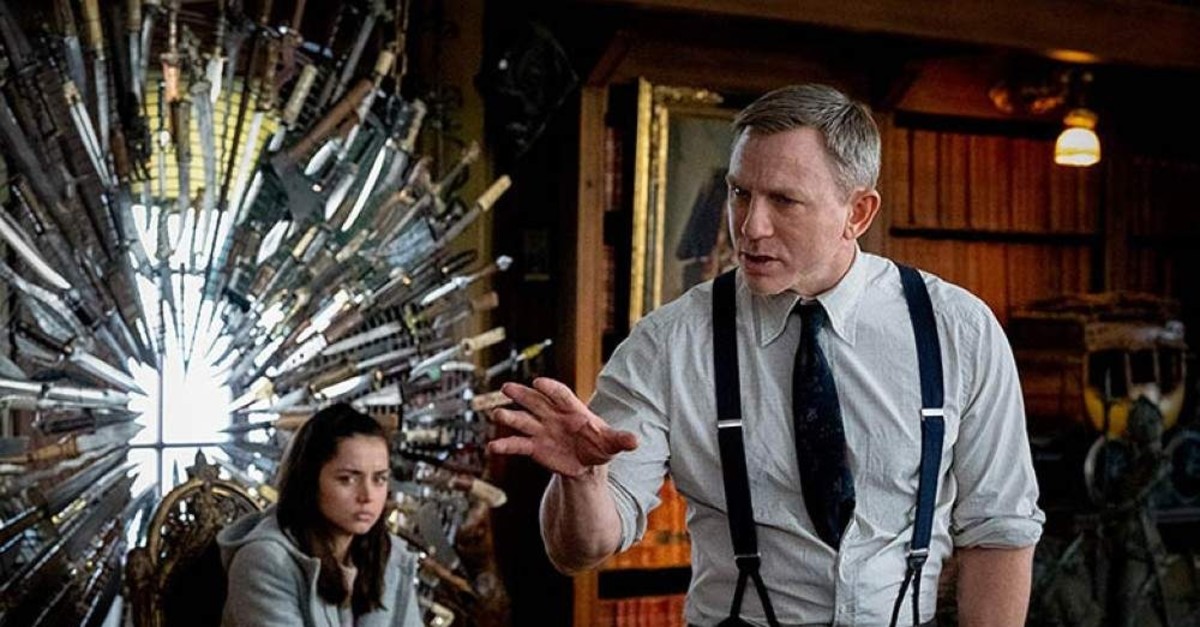 Ana de Armas as Marta Cabrera and Daniel Craig as Benoit Blanc in ,Knives Out., 