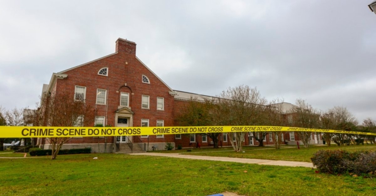 This handout photo released on Dec. 7, 2019 by the FBI shows Police tape stretching across a street near a building after an active shooting incident at a naval base in Pensacola, Florida. (Photo by Handout / FBI / AFP)