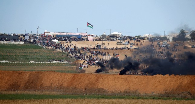 Smoke rises as Palestinians protest near the border fence on the Gaza side of the Israel-Gaza border, as seen from the Israeli side of the border, May 14, 2018 (Reuters Photo)