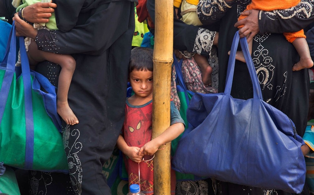 A Rohingya Muslim boy stands in a queue outside a food distribution center at Balukhali refugee camp, Bangladesh, Jan. 15.