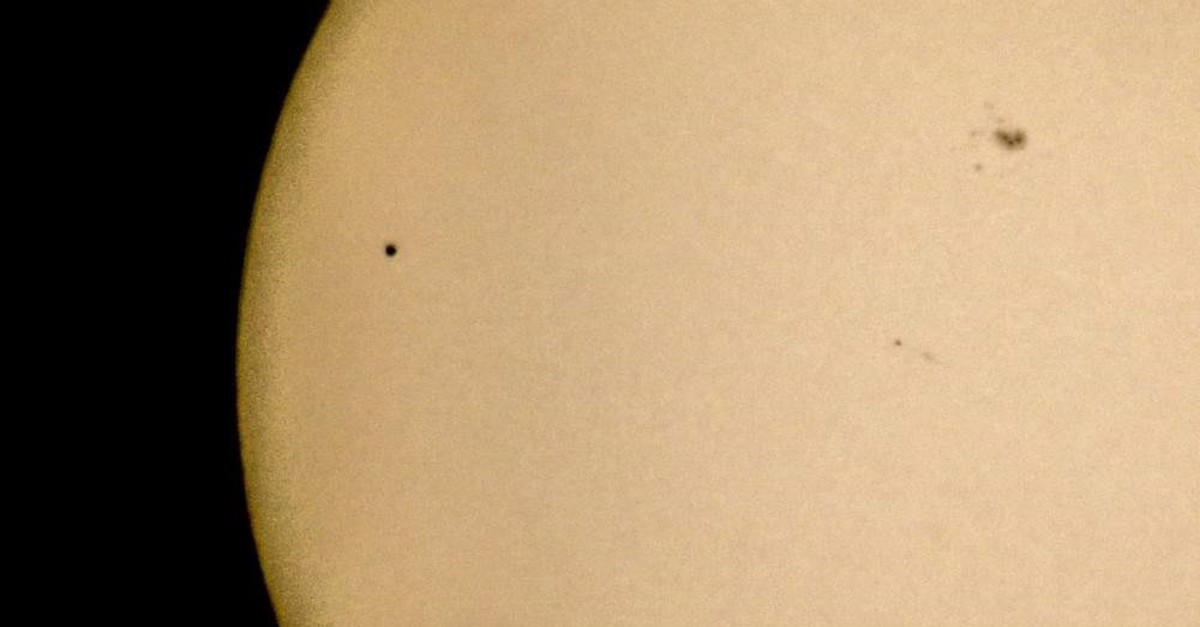 Mercury, seen as a small black dot on the top left, passes in front of the sun as observed from Stockholm, Sweden, May 9, 2016. (AP Photo)