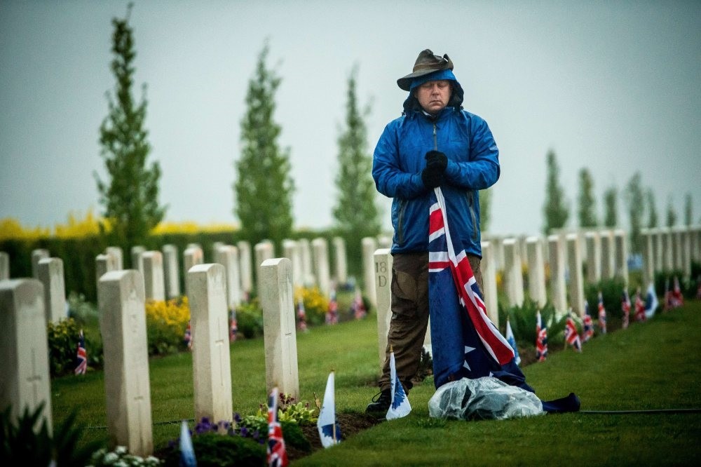 A man pays his respect to fallen Australian soldiers died in the Battle of Gallipoli during a dawn ceremony marking the 100th anniversary of Anzac Day on April 25, 2015.
