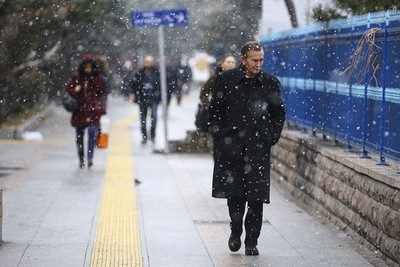 Ankara residents walk through morning snowfall. (AA)