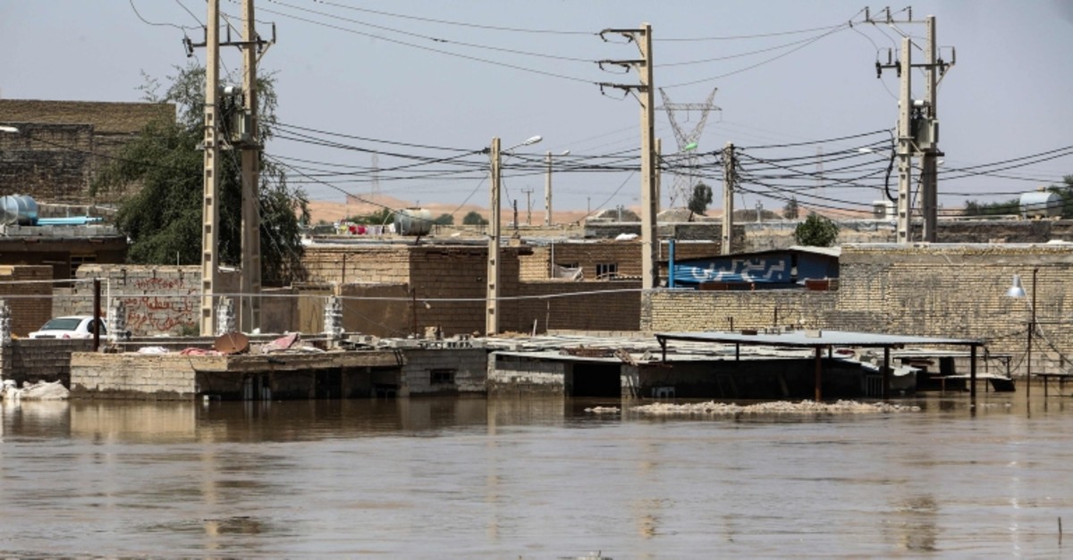 This picture taken on April 10, 2019 shows trees and buildings partially submerged by water from floods in Hamidiyeh, in Iran's western Khuzestan province. (AP Photo)