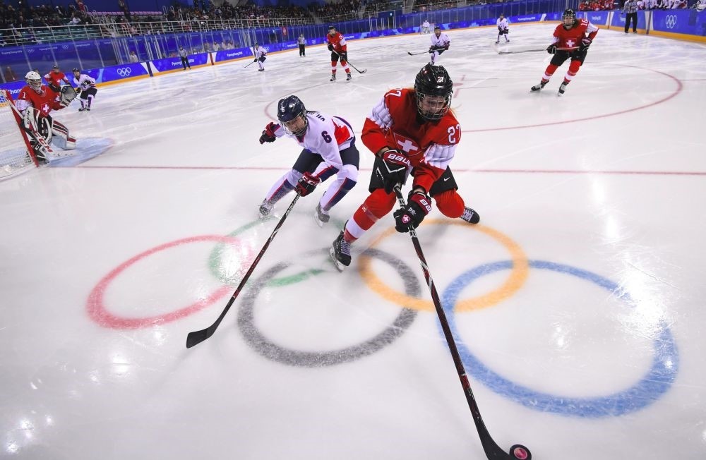 Switzerland's Stefanie Wetli (R) and Unified Korea's Choi Yujung  fight for the puck in the women's classifications (5-8) ice hockey match during the Pyeongchang 2018 Winter Olympic Games.