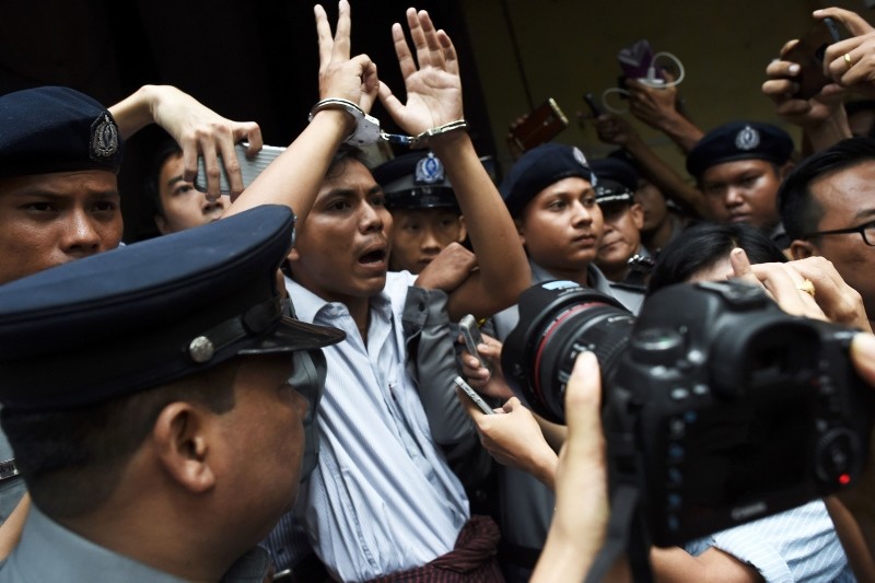 This file photo taken on September 03, 2018 shows Myanmar journalist Kyaw Soe Oo (C) is escorted by police after being sentenced by a court to jail in Yangon. (AFP Photo)