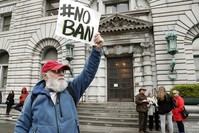 An anti-travel ban protestor with a poster reading 'NO BAN' stands outside the Ninth US Circuit Court of Appeals (EPA Photo)