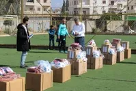 An official from Turkey's southern Hatay province distributes football and table tennis equipment as well as backpacks and jerseys to students in Afrin, Feb. 7, 2019.
