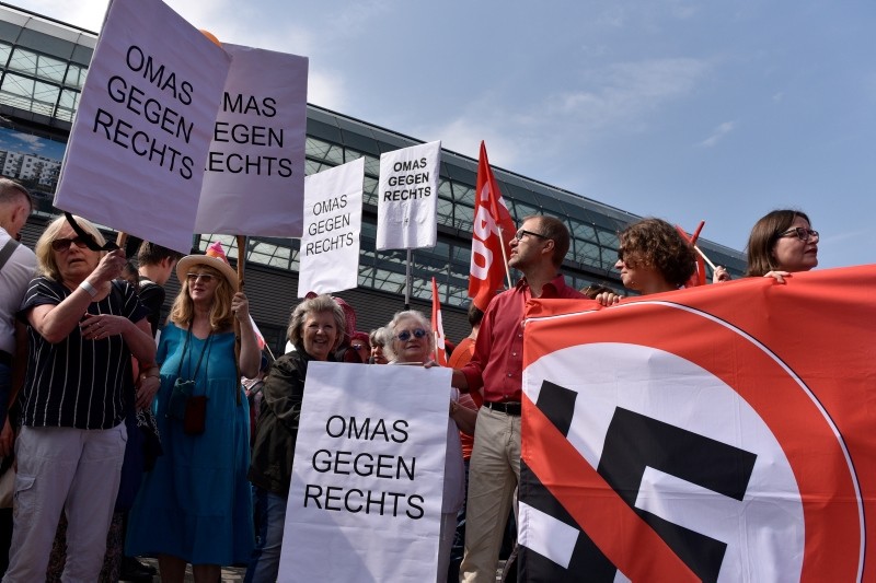 Elder ladies hold displays reading 'Grandmas against the right wing' during a demonstration against a gathering of far-right organizations commemorating the death anniversary Rudolf Hess in the district of Spandau in Berlin, Germany. (EPA Photo)