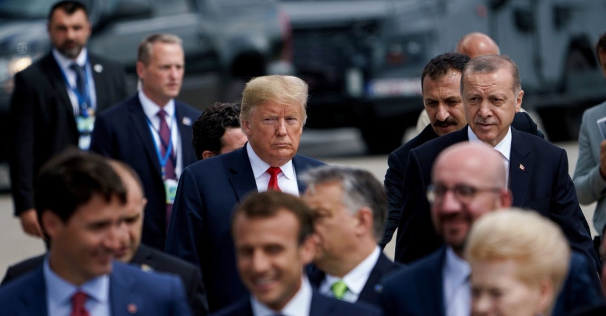 President Erdou011fan and U.S. President Trump (L) follow other leaders to a family photo during a NATO summit at NATO headquarters, Brussels, July 11, 2018.