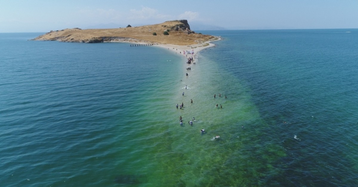 Swimmers seen approaching the u00c7arpanak Island located in Lake Van on Saturday Aug. 31, 2019 in Turkey's eastern Van province (IHA Photo)