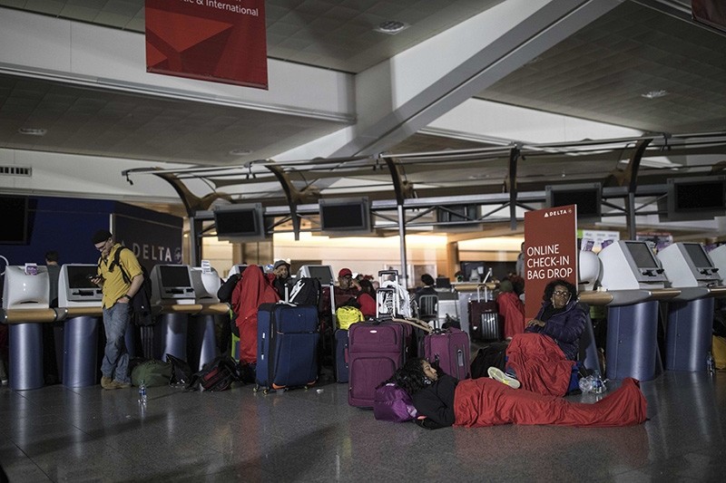 Passengers wait after the lights went out at Hartfield-Jackson Atlanta International Airport, Sunday, Dec. 17, 2017, in Atlanta. A sudden power outage at the airport on Sunday grounded scores of flights and passengers. (AP Photo)