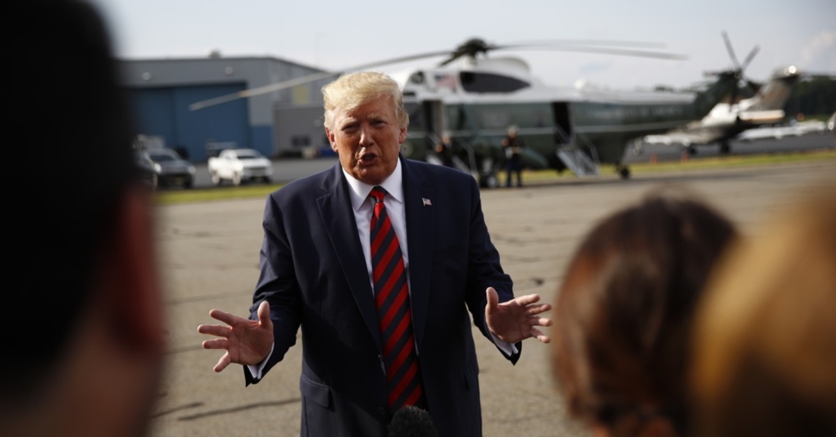 U.S. President Donald Trump speaks with reporters before boarding Air Force One at Morristown Municipal Airport in Morristown, N.J., Aug. 18, 2019.