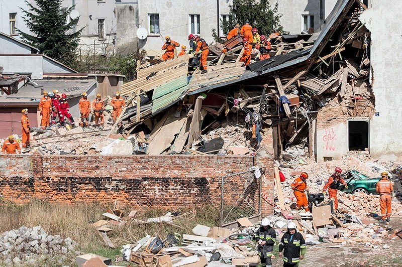 Polish emergency staff and firefighters work at the scene of a gas explosion that caused a tenement building to collapse in Swiebodzice, Poland. (EPA Photo)