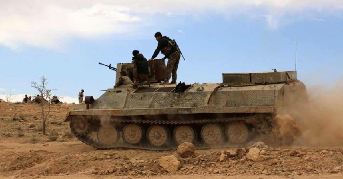 YPG terrorists sit atop an armored personnel carrier in the northeastern Syrian province of Hasaka, Feb. 19, 2016. (AFP)