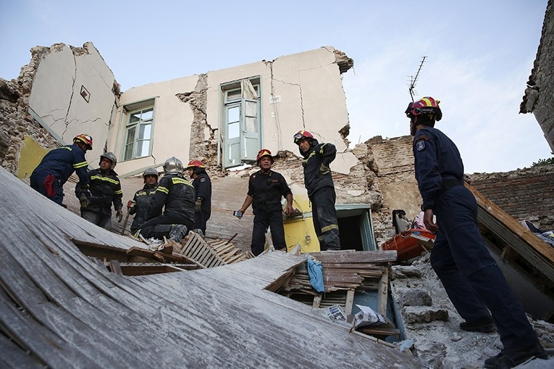 Fire department rescue team search for survivors, trapped in a collapsed house in the village of Vrissas, following a strong earthquake struck Lesvos island, in Greece, 12 June 2017. (EPA Photo)