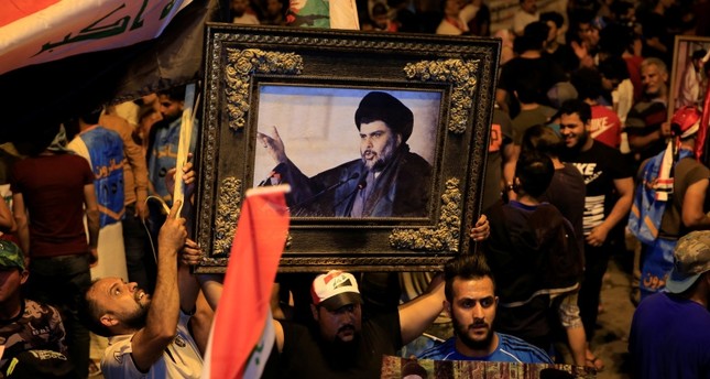 Supporters of Muqtada al-Sadr celebrate initial election results in Baghdad's Tahrir Square, on May 14, 2018. (AA Photo)