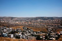 A view of Palestinian houses in the village of Wadi Fukin with the Israeli settlement of Beitar Illit in the background, the occupied West Bank, June 19, 2019. REUTERS