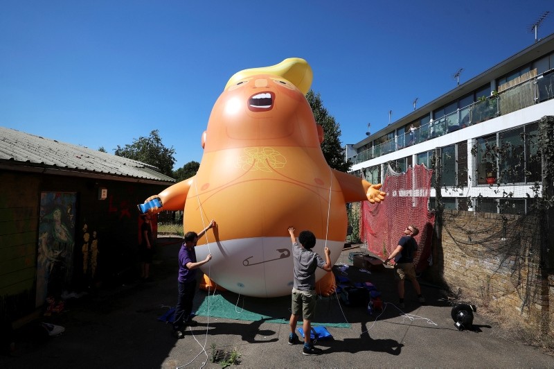 People inflate a helium filled Donald Trump blimp which they hope to deploy during The President of the United States' upcoming visit, in London, Britain, June 26, 2018. (REUTERS Photo)