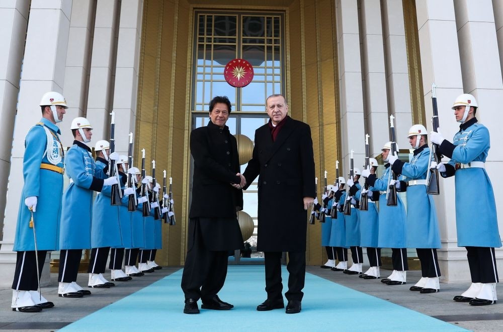 President Recep Tayyip Erdou011fan (R) welcoming Pakistan's Prime Minister Imran Khan (L) ahead of their meeting at the Presidential Complex in Ankara, on Friday.